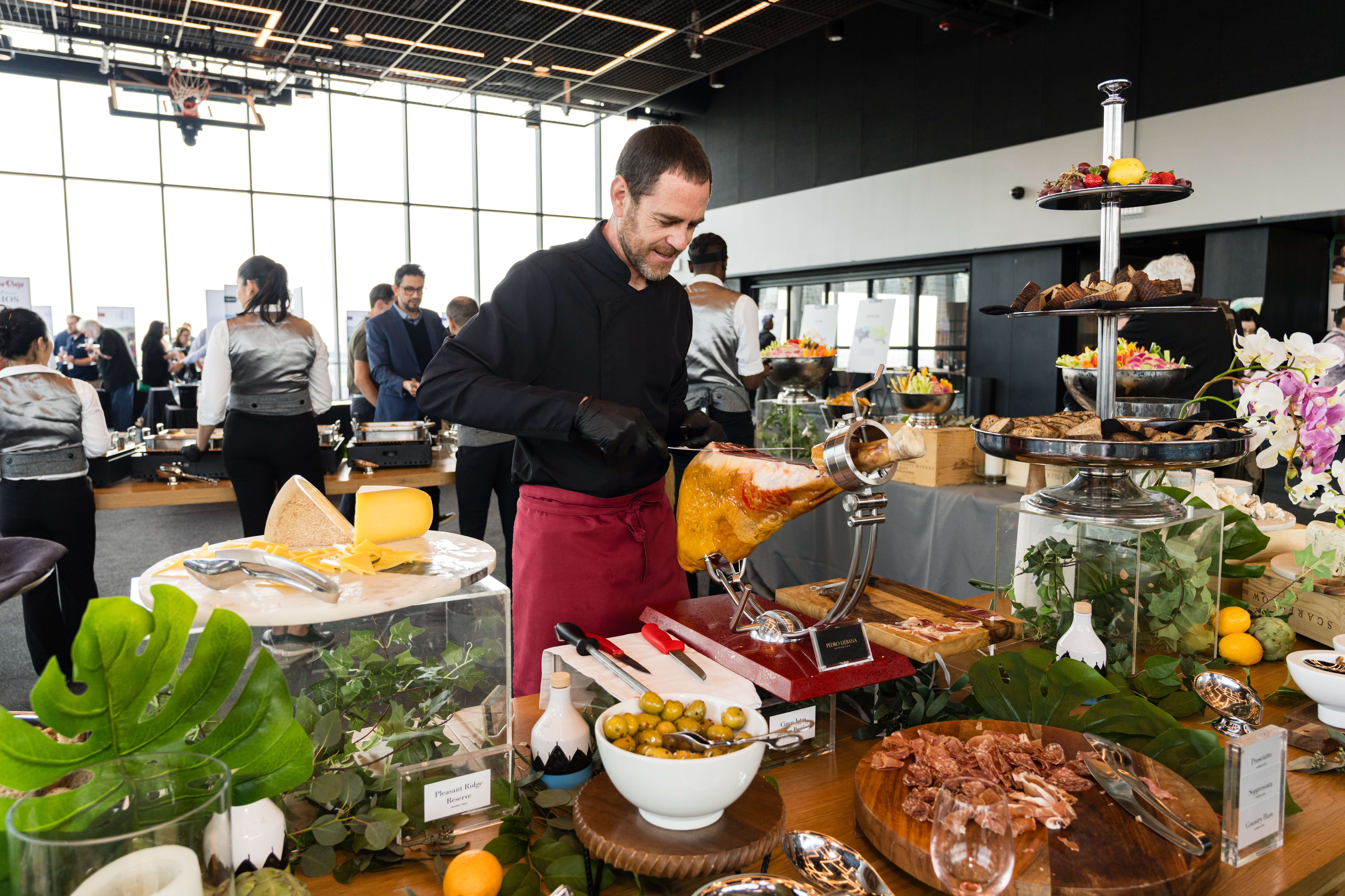A chef stands at a table of food