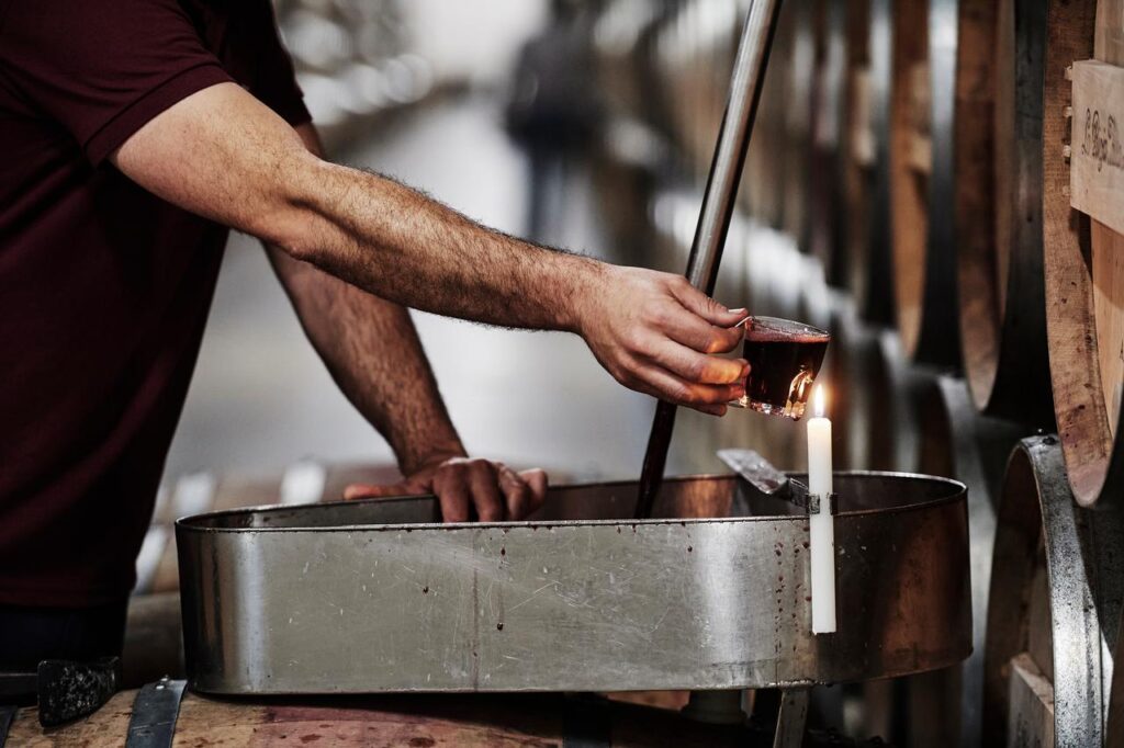 Pouring wine from a barrel